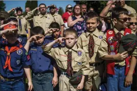  ?? AP PHOTO BY JAKE MAY ?? In this May 29photo, Boy Scouts and Cub Scouts salute during a Memorial Day ceremony in Linden, Mich. On Wednesday the Boy Scouts of America Board of Directors unanimousl­y approved to welcome girls into its Cub Scout program and to deliver a Scouting...