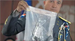  ?? ROBERTO GUZMAN/AP ?? Dominican police show the weapon they say was used to shoot David Ortiz on Sunday.