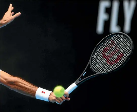  ?? GETTY IMAGES ?? Roger Federer looks a picture of cool as he plays a backhand against Daniel Evans during their Australian Open second round match.