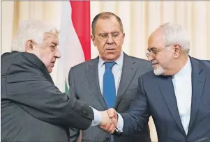  ?? AP PHOTO ?? Russian Foreign Minister Sergey Lavrov (centre) watches as Syrian Foreign Minister Walid Muallem (left) and Iranian Foreign Minister Mohammad Javad Zarif shake hands after a shared press conference following their talks focused on Syria in Moscow,...