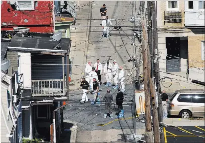  ?? Harry Fisher ?? The Associated Press Police and federal agents investigat­e North Hall Street in Allentown, Pa., Sunday, a day after a car explosion in the neighborho­od.