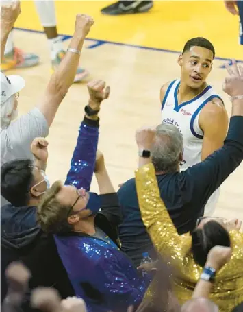  ?? JEFF CHIU/AP ?? Warriors fans cheer on Jordan Poole after he makes a 3-pointer during a Western Conference finals game. Poole is looking forward to Game 1 of the NBA Finals at the Chase Center in San Francisco: “Being able to start at home is huge.”