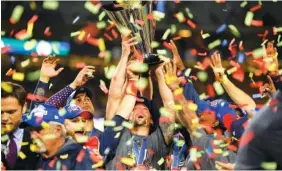  ?? ASSOCIATED PRESS PHOTOS ?? The U.S. team celebrates its 8-0 win over Puerto Rico in the final of the World Baseball Classic in Los Angeles on Wednesday. Below: U.S. infielder Eric Hosmer, right, and Nolan Arenado celebrate the win.