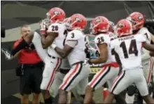  ?? JOHN RAOUX — THE ASSOCIATED PRESS ?? Georgia defensive back J.R. Reed (20) celebrates with teammates including linebacker Roquan Smith (3), defensive back Tyrique McGhee (26) and defensive back Malkom Parrish (14) after he recovered a Florida fumble and scored a touchdown against Florida.