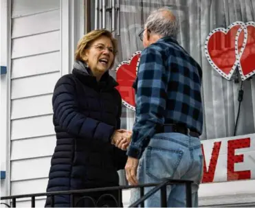  ?? RUTH FREMSON ?? Senator Elizabeth Warren shook hands with a voter while campaignin­g for president in Manchester, N.H., in 2020.