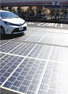  ?? — Japan News-Yomiuri photo ?? Solar panels are seen at a parking lot in Sagamihara, Kanagawa Prefecture. The durability of the panels is reinforced so that cars can pass over them.