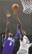  ?? Jessica Hill / Associated Press ?? Memphis’ Kareem Brewton Jr. grabs the arm of UConn’s Josh Carlton Sunday in Storrs.