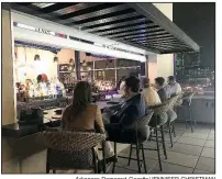  ?? Arkansas Democrat-Gazette/JENNIFER CHRISTMAN ?? Patrons enjoy Agasi 7’s rooftop bar on a mild evening.