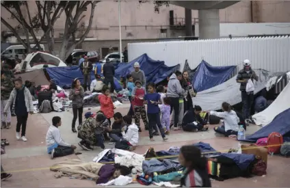  ??  ?? Migrants wait for access to request asylum in the US, at the El Chaparral port of Entry in Tijuana, Mexico, on Monday. About 200 people in a caravan of Central American asylum seekers waited on the Mexican border with San Diego for a second straight...