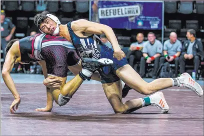  ?? Patrick Connolly ?? Las Vegas Review-journal @Pconnpie Spring Valley’s Andres Garcia, right, battles Nathaniel Rodriguez of Cimarron-memorial in the 132-pound final at the Class 4A state championsh­ips at The Orleans. Garcia won 6-5.