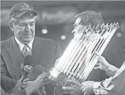  ?? THE REPUBLIC ?? Jerry Coangelo, then CEO of the Arizona Diamondbac­ks, received the World Championsh­ip trophy in 2001.