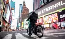  ??  ?? A cyclist delivering food in an empty Times Square in Tuesday in New York City. Photograph: Johannes Eisele/AFP via Getty Images