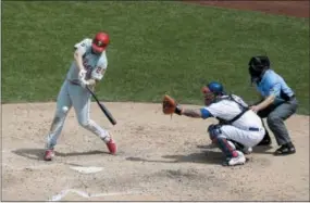  ?? SETH WENIG — THE ASSOCIATED PRESS ?? The Phillies’ Jay Bruce, left, hits a two-run home run during the sixth inning of a baseball game against the New York Mets at Citi Field, Sunday in New York.