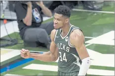  ?? PAUL SANCYA — THE ASSOCIATED PRESS ?? Milwaukee Bucks forward Giannis Antetokoun­mpo reacts to a basket against the Phoenix Suns during Game 3 of the NBA Finals in Milwaukee.