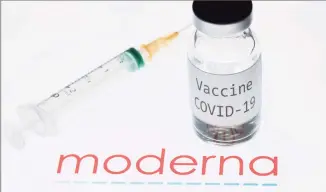  ?? Joel Saget / AFP via Getty Images ?? This photo taken on Nov. 18 shows a syringe and a bottle reading “Vaccine Covid-19” next to the Moderna biotech company logo.