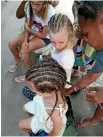  ??  ?? Getting braids.