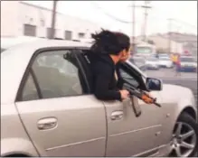  ?? NORTHERN DISTRICT CALIFORNIA COURT RECORDS ?? Federal prosecutor­s claim that Christophe­r GonzalezNu­ñez, 26, was driving this Cadillac during the 2021 sideshow where this viral Bay Area photo of a woman carrying an AK-47 weapon was taken.