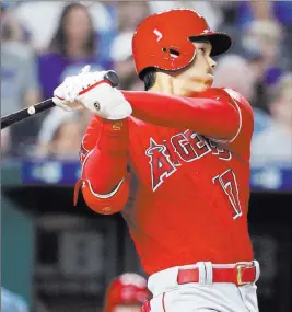  ?? Charlie Riedel ?? The Associated Press Shohei Ohtani follows through on a three-run triple in a five-run seventh inning for the Angels in their 7-1 victory over the Royals on Thursday at Kauffman Stadium.
