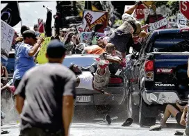  ?? RYAN M. KELLY / THE DAILY PROGRESS ?? People flfly into the air as a vehicle drives into a group of protesters demonstrat­ing against awhite nationalis­t rally in Charlottes­ville, Va., on Aug. 12. Lawenforce­ment agencies around the country are honing their responses to a string of rallies...