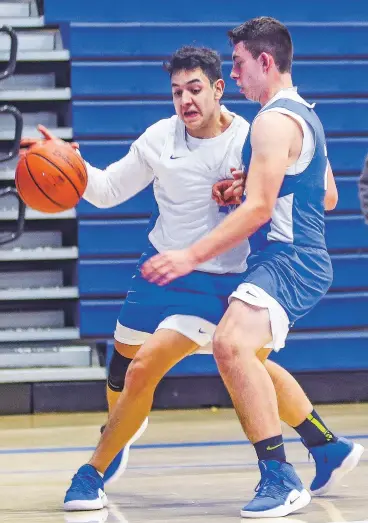  ?? GABRIELA CAMPOS/NEW MEXICAN FILE PHOTO ?? St. Michael’s Jevon Montoya, right, and Dominic Morgan at a Nov. 26 practice. The Horsemen are playing Roswell early today in the Bobby Rodriguez Capital City Tournament at Santa Fe High.