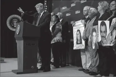  ?? The Associated Press ?? SOUTH COURT AUDITORIUM: President Donald Trump speaks about immigratio­n alongside family members affected by crime committed by undocument­ed immigrants on Friday at the South Court Auditorium on the White House complex in Washington.