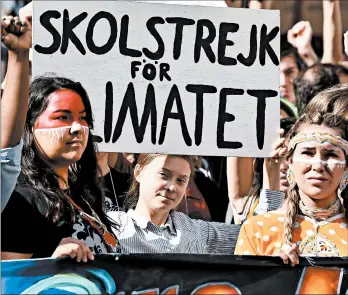  ?? MINAS PANAGIOTAK­IS/GETTY ?? Greta Thunberg, center, of Sweden, and other activists rally for action on climate change in Montreal on Friday, one of similar events by hundreds of thousands around the world.