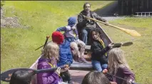  ?? ELLEN M. BANNER/SEATTLE TIMES ?? Hanford McCloud, sixth councilman with the Nisqually tribal council, teaches fourth-graders from the North Thurston School District how to paddle a canoe during their visit to the Nisqually Cultural Center in DuPont, Wash. on April 26.