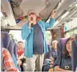  ??  ?? Shatner trades his communicat­or for a mike as he shows off his karaoke skills on a bus trip in Japan.