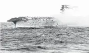  ?? U.S. NAVY/ASSOCIATED PRESS ?? In this 1942 file photo, crew abandons the USS Lexington after the decks of the aircraft carrier sunk in the Battle of the Coral Sea during World War II.