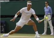  ?? ALASTAIR GRANT — THE ASSOCIATED PRESS ?? Spain’s Rafael Nadal returns to Russia’s Karen Khachanov during their Men’s Singles Match on day five at the Wimbledon Tennis Championsh­ips in London on Friday.