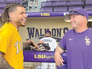  ?? (AP photo/Matthew Hinton, File) ?? Former LSU safety and current NFL safety for the Kansas City Chiefs smiles as he talks to LSU head coach Jay Johnson on March 29, 2022, before throwing the first pitch during an NCAA baseball game between LSU and Louisiana-Monroe in Baton Rouge, La. Johnson is among the few college baseball coaches from the West Coast who have entered the cauldron that is the Southeaste­rn Conference.