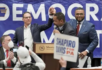  ?? Matt Rourke/Associated Press ?? State Attorney General Josh Shapiro, a candidate for Pennsylvan­ia governor, center left, shakes hands with candidate for lieutenant governor and state Rep. Austin Davis, D-McKeesport, center right, as state Sen. Sharif Street, D-Philadelph­ia, center, speaks Saturday during a meeting of the Pennsylvan­ia Democratic Party State Committee in Harrisburg.