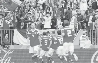  ??  ?? The Russian players and crowd celebrate another goal in their 5 – 0 drubbing of Saudi Arabia in the opening game of the 2018 World Cup yesterday in Moscow. (Photo courtesy of FIFA.com)