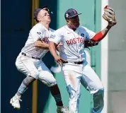  ?? Michael Dwyer/Associated Press ?? Boston Red Sox’s Rafael Devers, center, collides with teammate Tyler O’Neil after making the catch on a pop out by Cleveland Guardians’ Estevan Florial as Ceddanne Rafaela, right, looks on during the seventh inning Monday in Boston.