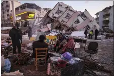  ?? EMRAH GUREL — THE ASSOCIATED PRESS ?? People stand by collapsed buildings in Golbasi, in Adiyaman province, southern Turkey, Wednesday, Feb. 8, 2023.