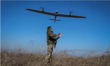  ?? Ratushniak/Reuters ?? A serviceman launches a Ukrainian mid-range reconnaiss­ance drone near Bakhmut, Donetsk region, on 12 March. Photograph: Oleksandr