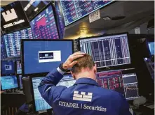  ?? Drew Angerer / Getty Images ?? A trader works during the closing bell Tuesday at the New York Stock Exchange. Markets dipped sharply again, with the Dow Jones Industrial Average down more than 500 points.