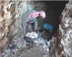  ??  ?? A man removes brackets of stone as he digs a cave in the Syrian village of Kafr Ain in the southern countrysid­e of the rebel-held Idlib province. — AFP photo