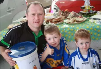  ??  ?? Ciaran Kennedy with his sons Danny and Tommy.