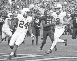  ?? KAMIL KRZACZYNSK­I / USA TODAY SPORTS ?? Penn State quarterbac­k Trace McSorleysc­ores a touchdown against the Northweste­rn Wildcats during the second half at Ryan Field.