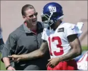  ?? SETH WENIG — THE ASSOCIATED PRESS ?? New York Giants head coach Ben McAdoo, left, talks with Odell Beckham, Jr. during a NFL football training camp in East Rutherford, N.J., Sunday.