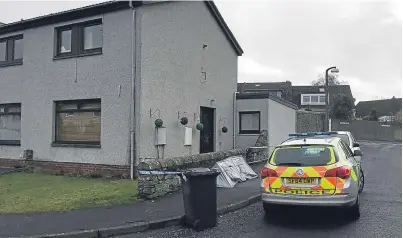  ??  ?? The police car and cordon outside the house in Castleroy Road, Broughty Ferry.