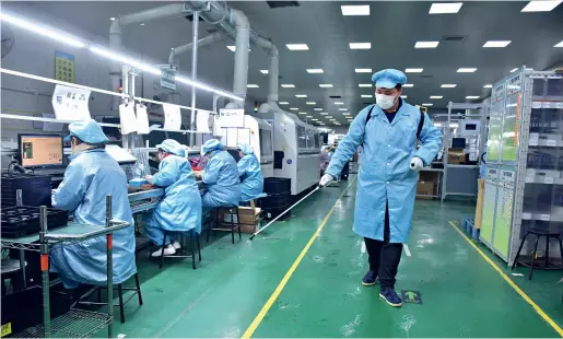  ??  ?? Workers spray disinfecta­nt in the workshop of Dongfangji­ule Automobile Airbag Co., Ltd. in Xinle, Shijiazhua­ng, Hebei Province, on February 17.