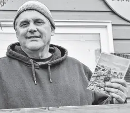  ?? RICHARD MACKENZIE • TRURO NEWS ?? Pictured just outside of a Tatamagouc­he Main Street business, artist Ron Mccormick holds up a couple of the cards that are being given away as part of his Cards of Comfort initiative.