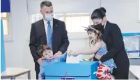  ?? (Jalaa Marey/Pool via Reuters) ?? NEW HOPE Party leader Gideon Sa’ar and his wife, Geula, vote at a polling station in Tel Aviv during the general election on March 23.