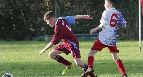  ??  ?? A determined Jack Brennan of Ferns United steals a march on Bunclody’s Oisín O’Leary.