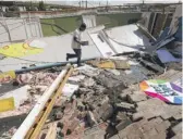  ?? ERIC GAY/AP ?? Benjamin Luna on Thursday helps recover items from the children’s wing of the First Pentecosta­l Church that was destroyed by Hurricane Laura in Orange, Texas.