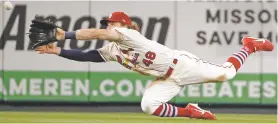  ?? JEFF ROBERSON/ASSOCIATED PRESS ?? Cardinals center fielder Harrison Bader makes a diving catch Saturday in St. Louis. The Cardinals beat the Brewers, 7-2.