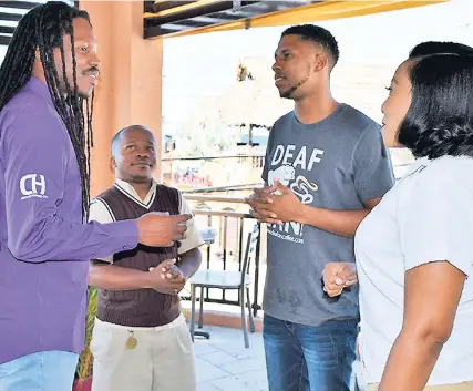  ?? OKOYE HENRY ?? Senator Damion Crawford (left) converses with (from second left) interprete­r for the day, Brevinal Ross, Deaf Can Coffee beneficiar­y and Café Mocha barista Kevin Smith, and co-owner of Café Mocha, Marlene Hacker. The event was a special sit-down with...