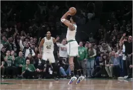  ?? CHARLES KRUPA — THE ASSOCIATED PRESS ?? Boston Celtics forward Jayson Tatum (0) shoots a 3-pointer during overtime of the team’s game against the Minnesota Timberwolv­es on Wednesday in Boston. Tatum scored 45 points in the 127-120 Celtics win.